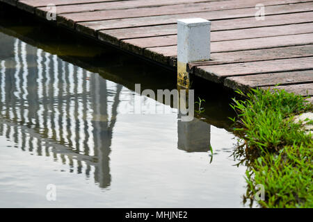 Ponte di legno la riflessione sul lago Foto Stock