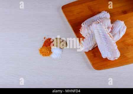 Ali di pollo piccanti, pronti da cucinare alla griglia Foto Stock