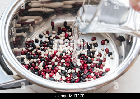 Risciacquare i fagioli in una pentola. Preparazione prima della cottura. Foto Stock