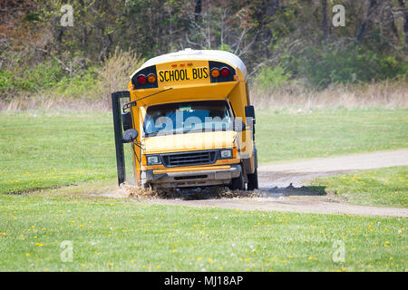 Scuola di pilotaggio del bus in fango bloccato sulla strada al giorno Foto Stock