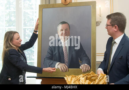 04 maggio 2018, Germania Stoccarda: lavoratori presso il ministero di stato svelando la pittura dell'ex premier Baden-Wuerttemberg da Cristiana Unione Democratica (CDU), Stefan Mappus, dipinta da photorealist Jan Peter Tripp Mappus è stata fotografata con il dipinto nella galleria del Baden-Wuerttemberg capo dei governi. Foto: Marijan Murat/dpa Foto Stock