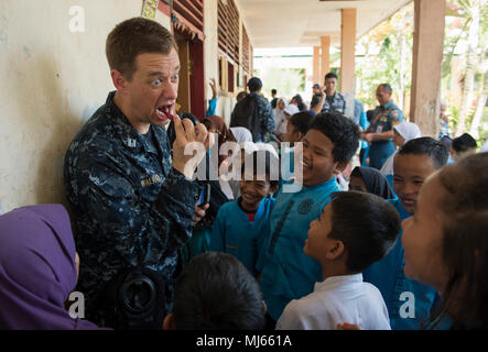 BENGKULU, Indonesia (Aprile 06, 2018) Lt. George Walrath, dalla Hacienda Heights, California, dimostra la salute dentale delle pratiche per gli studenti di SDN 77 Scuola Elementare di Bengkulu, Indonesia durante il partenariato del Pacifico 2018 (PP18). PP18's missione è lavorare collettivamente con host e nazioni partner per migliorare l'interoperabilità a livello regionale di emergenza e capacità di risposta, aumentando la stabilità e la sicurezza nella regione e favorire la nascita di nuove e durature amicizie in tutta la regione Indo-Pacifico. Pacific Partnership, ora nel suo tredicesimo iterazione, è la più grande multinazionale annuale di assistenza umanitaria un Foto Stock
