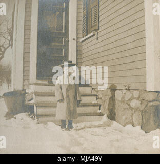 Antique c1905 la fotografia del giovane ragazzo in capi di abbigliamento in stile Vittoriano al di fuori in inverno. Posizione sconosciuta, probabilmente la Nuova Inghilterra, Stati Uniti d'America. Fonte: originale stampa fotografica. Foto Stock