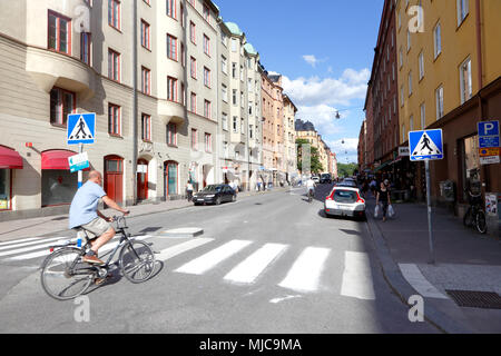 Stoccolma, Svezia - 27 Giugno 2016: Un ciclista si trasforma nella Norrbackagatan da Rörstrandsgatan nel quartiere di Vasastaden. Foto Stock