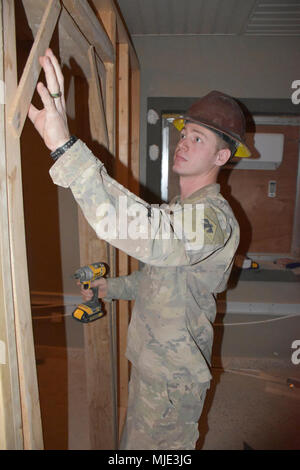 CAMP BUEHRING, Kuwait - Spc. Steven Ward of Oklahoma City mette le sue capacità civili come subappaltatore di utilizzare come egli frame a una porta per un nuovo ufficio in Iraq edificio doganale. Ward è un soldato con l'Ingegnere 2120th Company, ingegnere 458th battaglione, 35th Engineer brigata, Task Force Spartan. (U.S. Esercito Foto Stock