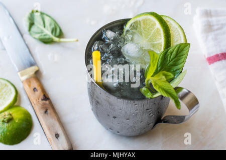 Moscow Mule Cocktail con lime e foglie di menta e ghiaccio tritato nel bicchiere di metallo. Bevanda estiva. Foto Stock