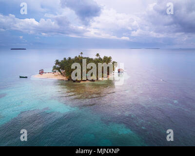 Piccola isola dei Caraibi su sfondo con cielo nuvoloso Foto Stock