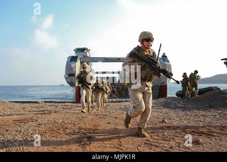 Stati Uniti Il personale marino Sgt. Christopher Smith con il quindicesimo Marine Expeditionary Unit alleggerimento del carico da un francese di landing craft durante una simulazione di assalto anfibio come parte di esercizio del coccodrillo di pugnale sulla spiaggia di Arta, Gibuti, Dic 20, 2017. Alligatore pugnale, guidato da Naval Amphibious vigore, Task Force 51/5th Marine Expeditionary Brigade, è un dedicato, bilaterali prove di combattimento che combina degli Stati Uniti e delle forze francesi di pratica, provare ed esercitare capacità integrate disponibili per gli Stati Uniti Comando centrale sia a galla e a terra. (U.S. Marine Corps foto di Sgt. Jessica Y. Lucio) Foto Stock