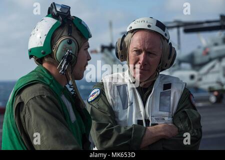 Stati Uniti Marine Corps Lance Cpl. Jacob Burns, sinistra, un drone maintainer con mezzo marino Tiltrotor Squadron (VMM) 162 (REIN), 26 Marine Expeditionary Unit (MEU), mutandine Navy Ammiraglio Kenneth Whitesell, il comandante del Carrier Strike gruppo (CSG) 4, sulla piccola tattica di velivoli senza pilota sistema (STUAS) sistema di avvio durante una visita a bordo il trasporto anfibio dock nave USS New York (LPD 21), nov. 15, 2017. Whitesell ha visitato la USS New York durante il composito combinato Unità Esercizio di formazione (COMPTUEX), il capstone evento per l'Iwo Jima anfibio gruppo Readiness (ARG Foto Stock