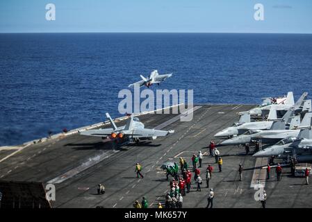 171115-N-GP724-1134 OCEANO PACIFICO (nov. 15, 2017) Un F/A-18E Super Hornet assegnati alla Stinger di Strike Fighter Squadron di attacco (VFA) 113 e un EA-18G Growler ssigned al Cougars di Attacco Elettronico Squadron (VAQ) 139 decollare dal ponte di volo della portaerei USS Theodore Roosevelt CVN (71). Theodore Roosevelt è distribuito negli Stati Uniti 7 area della flotta di azioni di sostegno le operazioni di sicurezza marittima e di protezione del teatro gli sforzi di cooperazione. (U.S. Foto di Marina di Massa lo specialista di comunicazione di terza classe Alex Perlman/rilasciato) Foto Stock