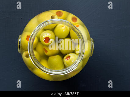 Vaso di olive verdi ripiene in salamoia close up top view foto con copia spazio per il testo Foto Stock