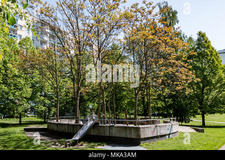 Parco giochi per bambini nel parco tra gli edifici residenziali in Berlin Marzahn, Germania Foto Stock