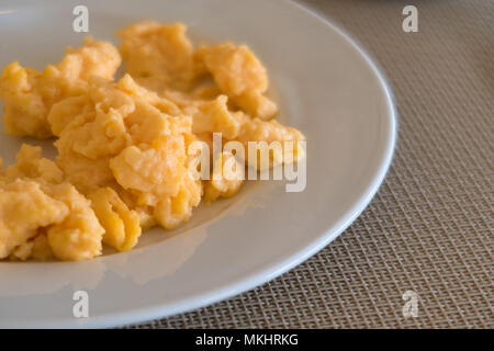 Uova strapazzate su una piastra bianca Foto Stock