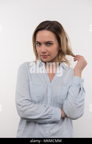 Bella donna attraente di toccare i capelli Foto Stock