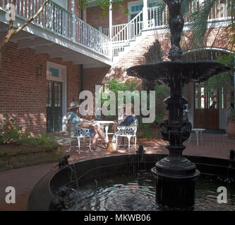 Amici in French Quarter Courtyard, New Orleans, in Louisiana. Foto Stock