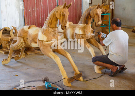 Lampang, Tailandia - 3 Novembre 2012: artigiano lucidatura di cavallo di legno scultura con macchina lucidatrice per mobili in officina in Lampang, tailandese Foto Stock