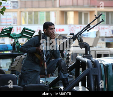 A Kabul, Afghanistan. Il 9 maggio 2018. (180509) -- KABUL, 9 maggio (Xinhua) -- un poliziotto afghano protezioni su un veicolo militare presso il sito di un attentato suicida nella Shahri Naw area del centro di Kabul, Afghanistan, 9 maggio 2018. Governo anti-militanti hanno lanciato offensive complesse su due stazioni di polizia in Afghanistan del capitale Kabul Mercoledì e finora sette persone sono state confermato morto e 17 feriti, mentre continuano gli scontri tra i miliziani e le forze di sicurezza nel centro di Kabul. (Xinhua/Rahmat Alizadah)(SRB) Credito: Rahmat Alizadah)(srb/Xinhua/Alamy Live News Foto Stock