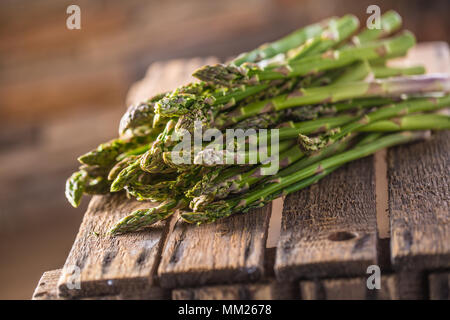 Freschi asparagi verdi giacente su una scatola di legno. Foto Stock