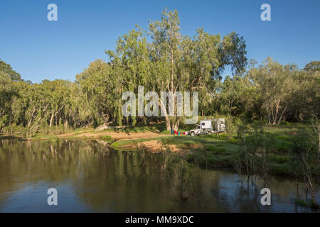 Veicolo per attività ricreative. Land Rover camper, in campeggio con splendide Australian foresta paesaggio & blue sky si riflette nelle calme acque del fiume Isacco Foto Stock