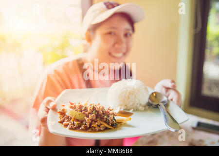 Thailandia Street cibo delizioso gustosi piatti di riso al gelsomino top con carne di maiale chop stir-fritte con foglia di basilico e uovo fritto più popolari alimenti presenti a turistica Foto Stock