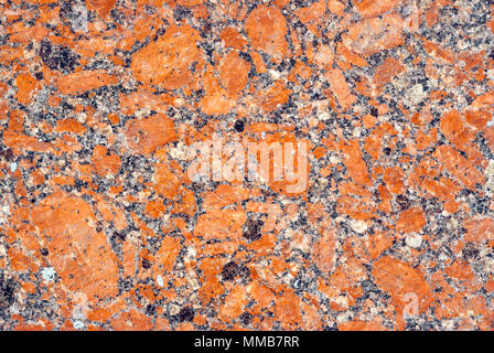 Background e texture - variegato di superficie levigata lastra di granito con orange impregnazioni Foto Stock