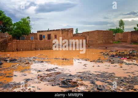 Allagate baraccopoli africana con un sacco di immondizia durante la stagione delle piogge (luglio-agosto), Ouagadougou, Burkina Faso, Africa occidentale. Foto Stock