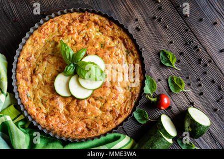 Tortino di zucchine con pancetta e formaggio, cipolla, prezzemolo e basilico Foto Stock