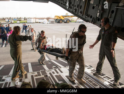 Cittadino di riserva aviatori assegnati per il quarantacinquesimo di medicina aeronautica squadrone di evacuazione, portano i pazienti a bordo di una C-17 Globemaster III in St. Croix, U.S. Isole Vergini, Sett. 24, 2017. Cittadino di riserva aviatori condotta missione umanitaria di St. Croix per evacuare le vittime colpite dall'uragano Maria. (U.S. Air Force foto di Tech. Sgt. Peter Dean) Foto Stock