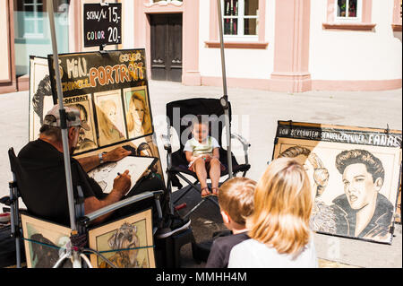 L'artista di strada il disegno di una bambina il ritratto Foto Stock