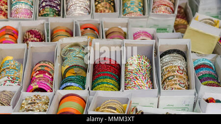 Un primo piano di scatole di coloratissimi schiave. L'assortimento di bracciali sono stati esposti per la vendita a Shilparamam, Hyderabad, India. Foto Stock