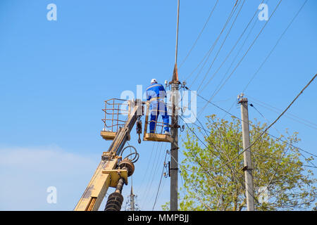 Slavyansk-su-Kuban, Russia - 24 April, 2018: elettricisti riparare la linea di alimentazione. I lavoratori sono di fabbro elettricisti. Foto Stock