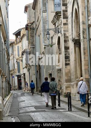Persone che camminano giù per una strada stretta nella città vecchia di Arles, Francia Foto Stock