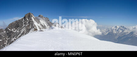 Panorama del paesaggio di montagna delle Alpi svizzere nei pressi di Zermatt in una bella giornata nel tardo inverno sotto un cielo blu Foto Stock