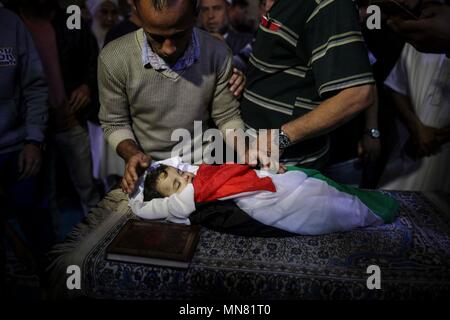 La striscia di Gaza. 15 Maggio, 2018. Persone in lutto e parenti ai funerali di di otto-mese-vecchio bambino palestinese Laila al-Ghandour, deceduto dopo inalazione di gas lacrimogeni durante una manifestazione di protesta al confine Israel-Gaza di Gaza City, il 15 maggio 2018. Il lunedì, le forze israeliane hanno ucciso decine di palestinesi e feriti più di duemila gli altri in un giorno lungo scontro lungo la striscia di Gaza-Israele confine. Credito: Wissam Nassar/Xinhua/Alamy Live News Foto Stock