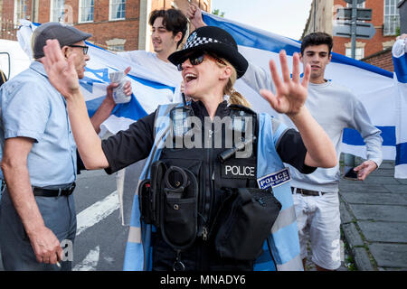 Bristol, Regno Unito. 15 Maggio, 2018. Gli agenti di polizia hanno mostrato come essi cercano di disperdere un piccolo gruppo di sostenitori Pro-Israel portando la bandiera israeliana come si confrontano Pro-Palestinian dimostranti che stavano prendendo parte a una marcia di protesta attraverso Bristol per manifestare la loro solidarietà con il popolo palestinese. La marcia di protesta e di rally è stato tenuto a consentire alle persone di mostrare il loro appoggio e la loro solidarietà con il popolo palestinese dopo 70 anni di La Nakba e protestare per Israele il recenti azioni nella Striscia di Gaza: Credito lynchpics/Alamy Live News Foto Stock