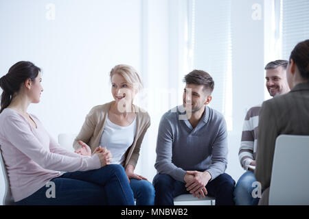 Persone che parlano in cerchio AA durante la riunione di gruppo Foto Stock