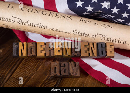 " Giorno di Indipendenza" testo utilizzando le lettere in legno con la dichiarazione di indipendenza del documento e United States Flag-americano concetto di vacanza Foto Stock