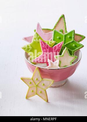 Una ciotola di coloratissimi stella di Natale biscotti Foto Stock
