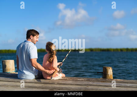 Padre di famiglia e figlia insieme di pesca dal pontile in legno Foto Stock