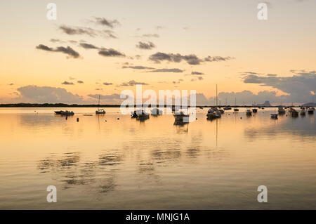 Ancorate le barche a vela e le nuvole la riflessione al tramonto a Estany des Peix marine lagoon a La Savina (Formentera, isole Baleari, Spagna) Foto Stock