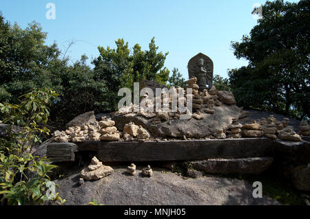 Rock statua di Budda in cima del monte Misen, l'isola di Miyajima, Giappone Foto Stock