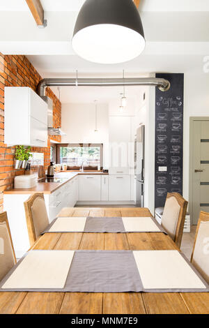 Inquadratura di un grande tavolo in una moderna sala da pranzo Foto Stock