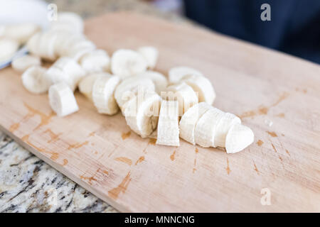 Un trito di banana congelata sul bambù in legno tagliere macro closeup Foto Stock