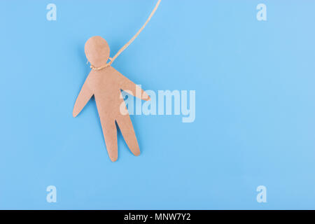 Appendere sé stesso concetto di persona della carta su sfondo blu Foto Stock