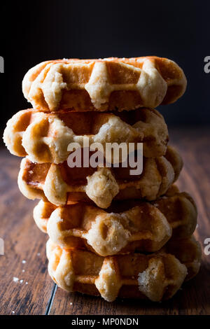 Pila di pianura Belgio Waffle su una superficie di legno. I cibi tradizionali. Foto Stock