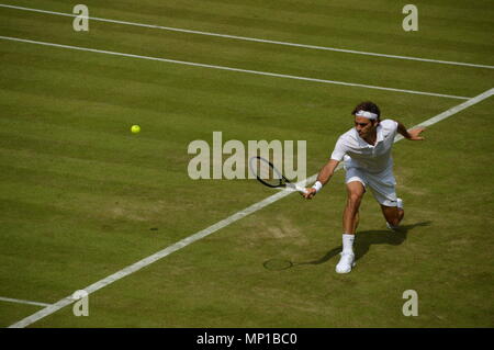 Roger Federer restituendo un colpo con una scritta a Wimbledon Foto Stock