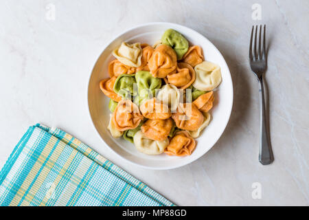 Tri colorato Tortellini / Multicolor o colorato. Il cibo italiano. Foto Stock