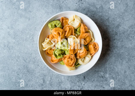 Tri colorato Tortellini / Multicolor o colorato. Il cibo italiano. Foto Stock