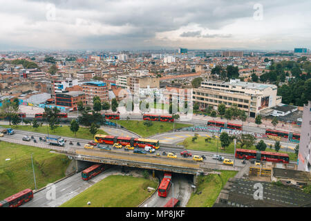 Vista aerea di mattina presto ora di punta dotata di numerosi taxi e articolato autobus Transmilenio in Colombia la capitale, Bogotà Foto Stock