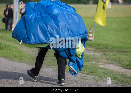 Parachutist con paracadute sulle spalle tornando a Base-Point dopo il lancio. Foto Stock